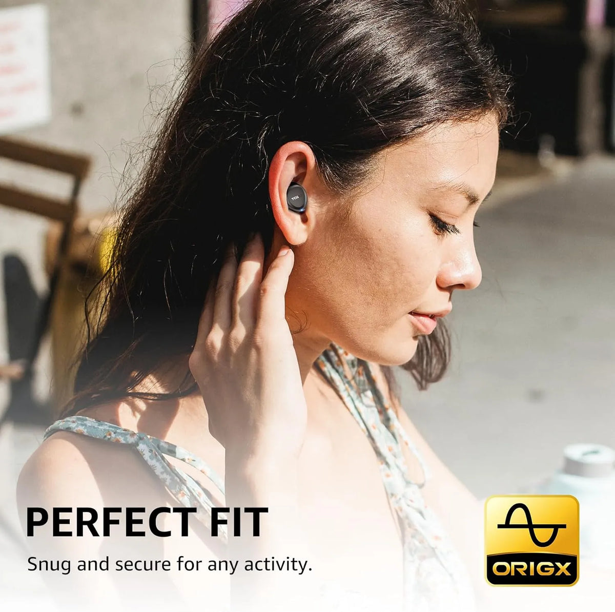 Woman wearing a wireless earbud with 'Origx' branding and text about perfect fit.