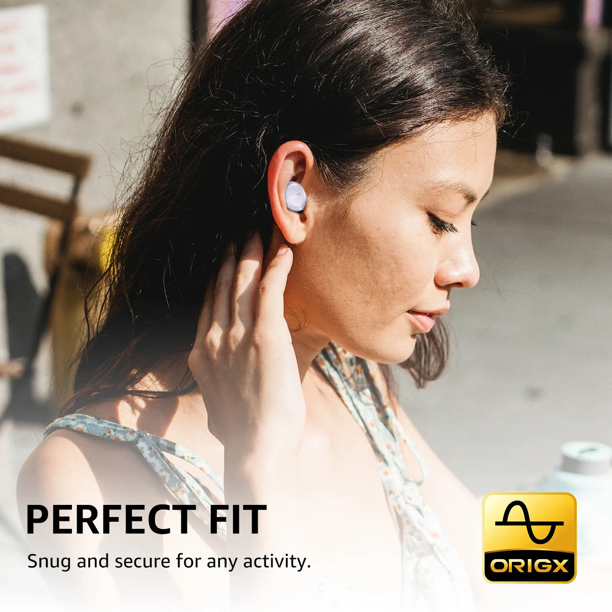 Woman wearing wireless earbuds with 'Origx' branding and text about perfect fit.