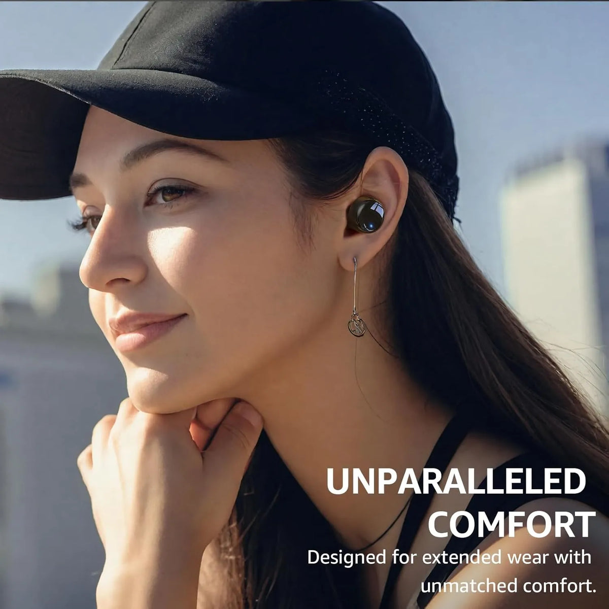 Woman wearing a black cap and earbud with text 'Unparalleled Comfort' on a blurred city background