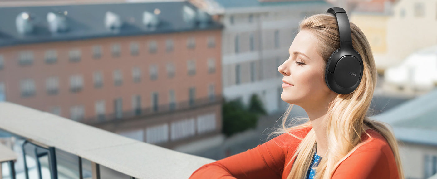 Woman relaxing with TOZO H100 black headphones